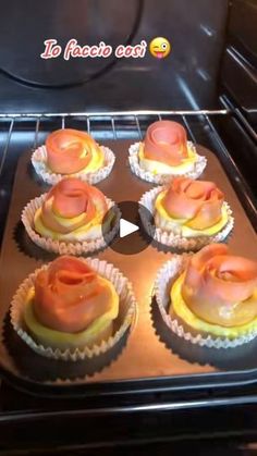 cupcakes with pink frosting in an oven