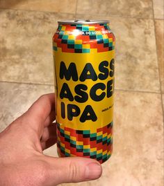 a hand holding up a can of masc asce pa on a tile floor