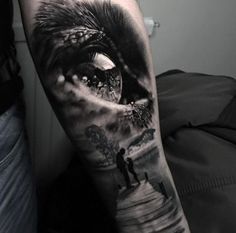 a man's arm with a black and white image of an eye on it