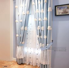 the curtains in this room are decorated with white and blue polka dotty dots on them