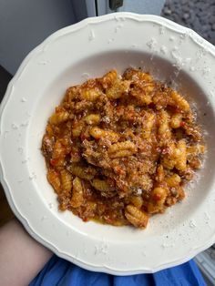 a white plate topped with pasta covered in sauce