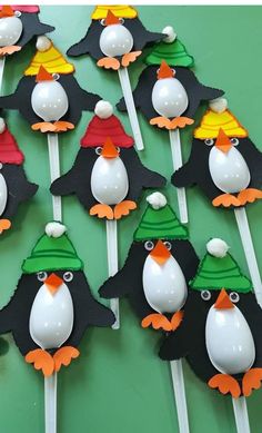 there are many penguins with hats on top of the cake pops that have been made to look like they're ready for christmas