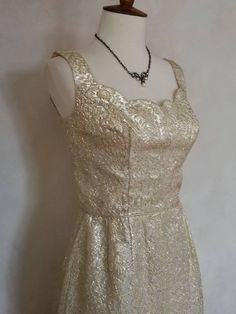 "Gold lame fashioned into a stunning formal dinner dress.  This gown is from the late 1950's early 1960's.  It is flawless and in mint condition. True vintage around sixty years old. Created by a designer Terrell Inc.  Junior Miss Fashion of Miami.  The form fitting  bodice has a scalloped neckline and fitted waist.   It is completely lined with a  working metal zipper in the back.  It has a split pleat on hemline in the back for easy walking.  The fabric is amazing and reflects the light and just glows.  I so wish I could add a video to my listing so you could see it.  True vintage Hollywood.    All my dresses are hand washed or dry cleaned prior to selling. If a dress has been repaired anywhere I will make note of it in the description. Thank you taking a peek at Pink Leaf Vintage. The m Elegant A-line Vintage Party Dress, Gold A-line Fitted Evening Dress, Party Evening Dress With Fitted Bodice, Tea Length, Elegant Evening Dress For Vintage Events With Fitted Bodice, Tea Length Evening Dress With Fitted Bodice For Party, Elegant Dress With Fitted Bodice For Vintage Events, Elegant A-line Vintage Dress For Party, Gold A-line Evening Dress For Cocktail, Gold Fitted A-line Evening Dress