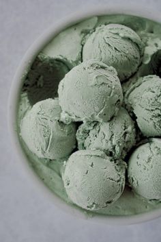 a white bowl filled with green ice cream