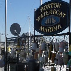 the sign for boston waterboat marina is covered in buoys and other things that are on display