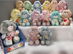 a group of stuffed animals sitting on top of a table next to a box of gummy bears