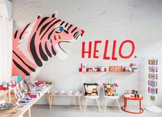 the children's room is decorated in pink, black and white with a tiger head painted on the wall