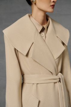 The trench coat showcases a quintessential piece of outerwear with a timeless silhouette. designed with all the classic features, such as a belted waist and a slit waterfall collar, it is presented in a versatile beige hue contributing to its originality. *Note:Processing time takes 5-8 working days (NOT including shipping time). Product Details - Product type: Trench Coat- Material: Felt Cloth- Long sleeves- Slit waterfall collar- Include belt- Flap pockets- Lined- Length: 127cm Size & Fit - Mo Elegant Belted Beige Pea Coat, Elegant Beige Belted Pea Coat, Elegant Notch Lapel Outerwear With Belt, Elegant Outerwear With Notch Lapel And Self Belt, Luxury Beige Pea Coat With Lapel Collar, Elegant Outerwear With Self Belt And Notch Lapel, Elegant Outerwear With Belt And Lapel Collar, Elegant Wool Coat With Belted Cuffs And Lapel Collar, Chic Wool Coat With Belted Cuffs And Lapel Collar