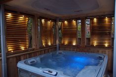 an indoor hot tub with wooden shutters