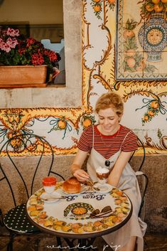 a woman sitting at a table eating food