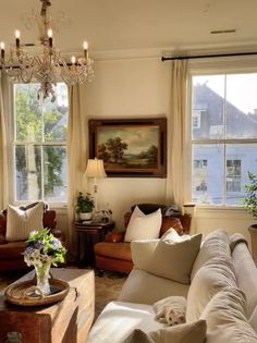 a living room filled with furniture and a chandelier