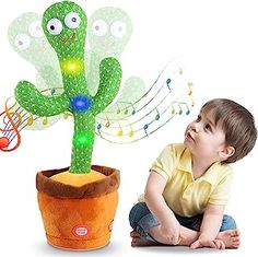 a young boy sitting on the ground next to a potted plant with musical notes coming out of it