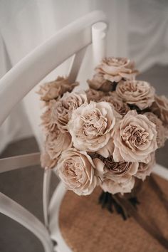 a bouquet of flowers sitting on top of a white chair