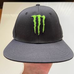 the monster trucker hat is black and green