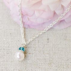 A beautiful freshwater pearl is topped with a shiny sterling silver daisy and a faceted genuine birthstone gemstone, making it extra personal. How sweet would this be for her birthday? Gorgeous hand-chosen AAA grade centerpiece pearl is approximately 7mm and is topped with a 3.5mm(ish) genuine gemstone. So pretty! Pearl Necklaces With Faceted Detail As Gift, Gift Pearl Necklace With Gemstone, Pearl White Gemstone Pearl Necklace Gift, Dainty Pearl Jewelry With Birthstone, Sterling Silver Pearl Necklace With Gemstone For Gift, Sterling Silver Pearl Necklace With Gemstone As A Gift, Pearl Jewelry For Birthday And Mother's Day, Elegant Pearl Drop Jewelry For Birthday, Pearl Charm Jewelry For May Birthstone Gift