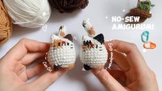 two small crocheted cats sitting next to each other