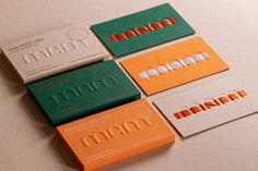 four different colored business cards sitting on top of each other