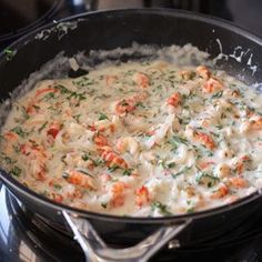 a pan filled with food sitting on top of a stove