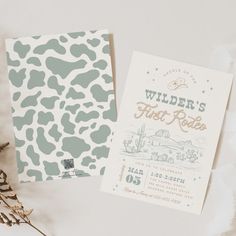 two wedding stationery cards on top of each other next to some dried flowers and leaves