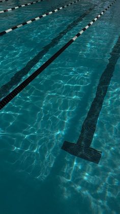 an empty swimming pool with blue water and no one in it or any people around