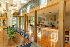 an open kitchen and dining room with wood flooring