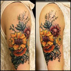 a woman's arm with flowers and leaves on it, both showing the same color