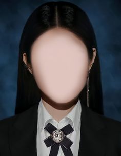 a woman with long black hair wearing a white shirt and black bow tie in front of her face