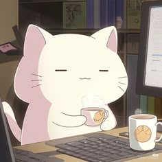 a cat sitting at a computer desk with a cup of coffee in front of it