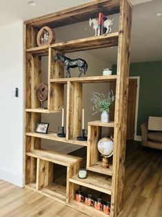 a wooden bookcase filled with lots of shelves and decorations on top of it's sides