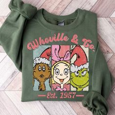 a green sweatshirt with cartoon characters on it