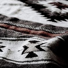 an old rug with black and white designs on it's edges is seen close up