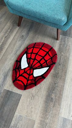 a spiderman rug is on the floor next to a chair