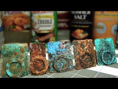 five different colored metal rings sitting on top of a counter next to some cereal boxes