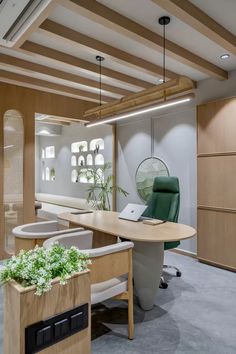 an office with wooden furniture and plants on the desk