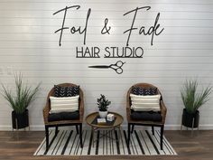 two chairs sitting next to each other in front of a sign that says foot & fade hair studio