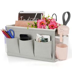 an organized storage bin with flowers and office supplies in the bottom section, on a white background