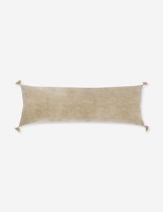 a rectangular pillow with tassels on it