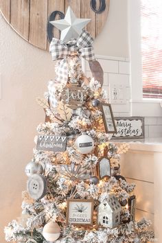 a white christmas tree decorated with ornaments