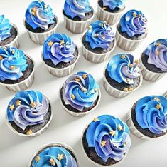 cupcakes with blue frosting and gold stars on them