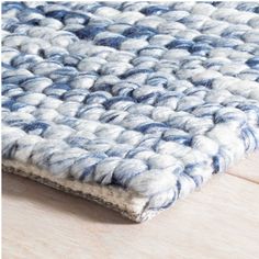 a blue and white rug is laying on the floor