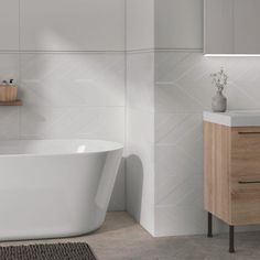 a white bath tub sitting next to a wooden cabinet in a bathroom under a window