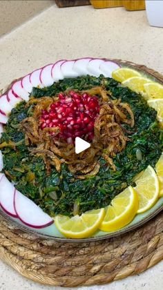 a white plate topped with greens and sliced lemons