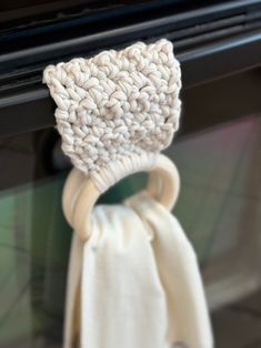 a close up of a knitted object hanging from a hook