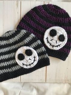 two crocheted hats with faces on them