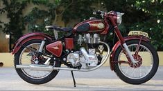 a red and black motorcycle parked on the street