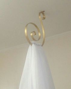 a white towel hanging from a hook on the ceiling