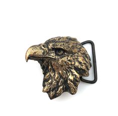 an eagle's head is attached to a black metal hook on a white background