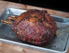 a large piece of meat sitting on top of a metal pan