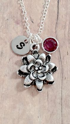 "This listing is for a hand stamped initial necklace featuring a 4/5\" x 3/5\" silver plated dahlia charm, 1/5\" birthstone pendant, & 3/10\" stainless steel initial pendant. The stainless steel bangle is 65mm (2.5\") in diameter and fits most adult women's wrists. All items are lead & nickel free. Please message me with any questions, thank you! Add an initial to any item: https://www.etsy.com/listing/170461597/add-an-initial?ref=shop_home_active&ga_search_query=Add Add a birthstone Silver Charm Necklace With Flower Charm For Mom, Personalized Silver Charm Necklace With Flower Pendant, Personalized Silver Flower Pendant Charm Necklace, Silver Hand Stamped Flower Pendant Jewelry, Silver Flower Pendant Jewelry Hand Stamped, Silver Jewelry With Birth Flower Initial Pendant, Silver Jewelry With Initial Pendant And Birth Flower, Personalized Sterling Silver Flower Necklace, Personalized Silver Flower Jewelry