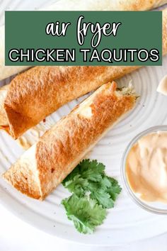 two chicken taquitass on a white plate with sauce and cilantro